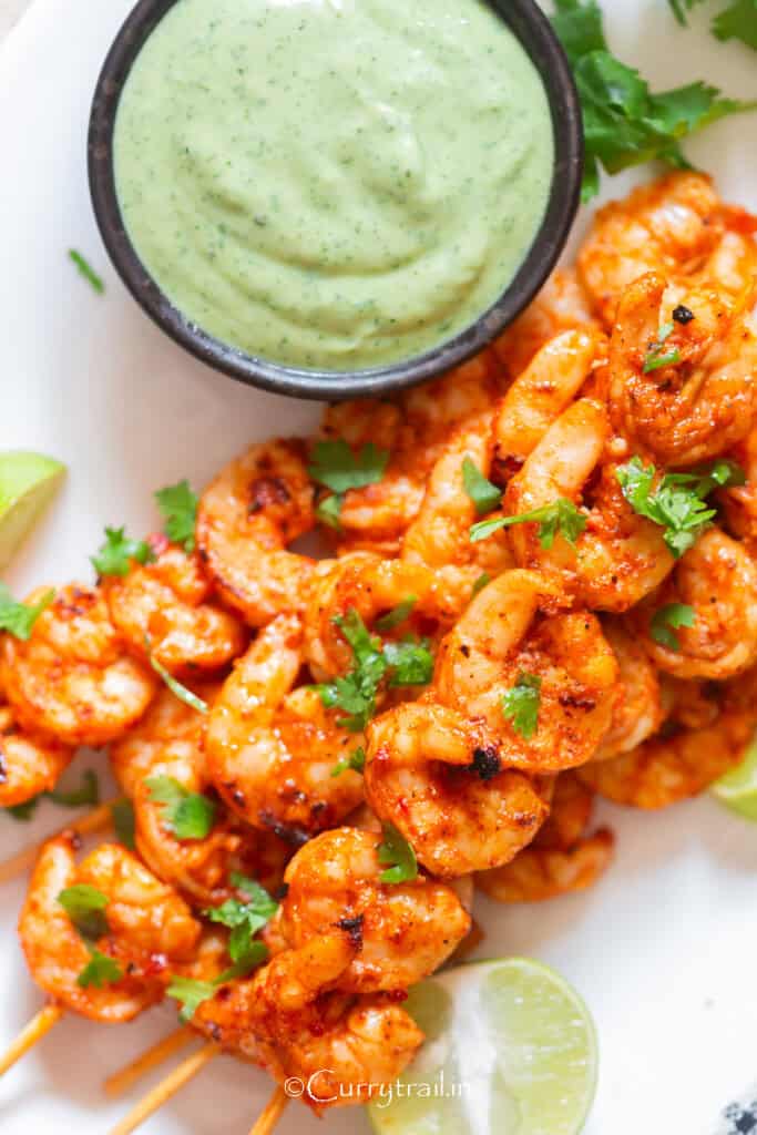 spicy grilled shrimp on bamboo skewers with avocado dip.