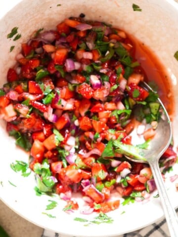fresh strawberry salsa in a bowl with a spoon.