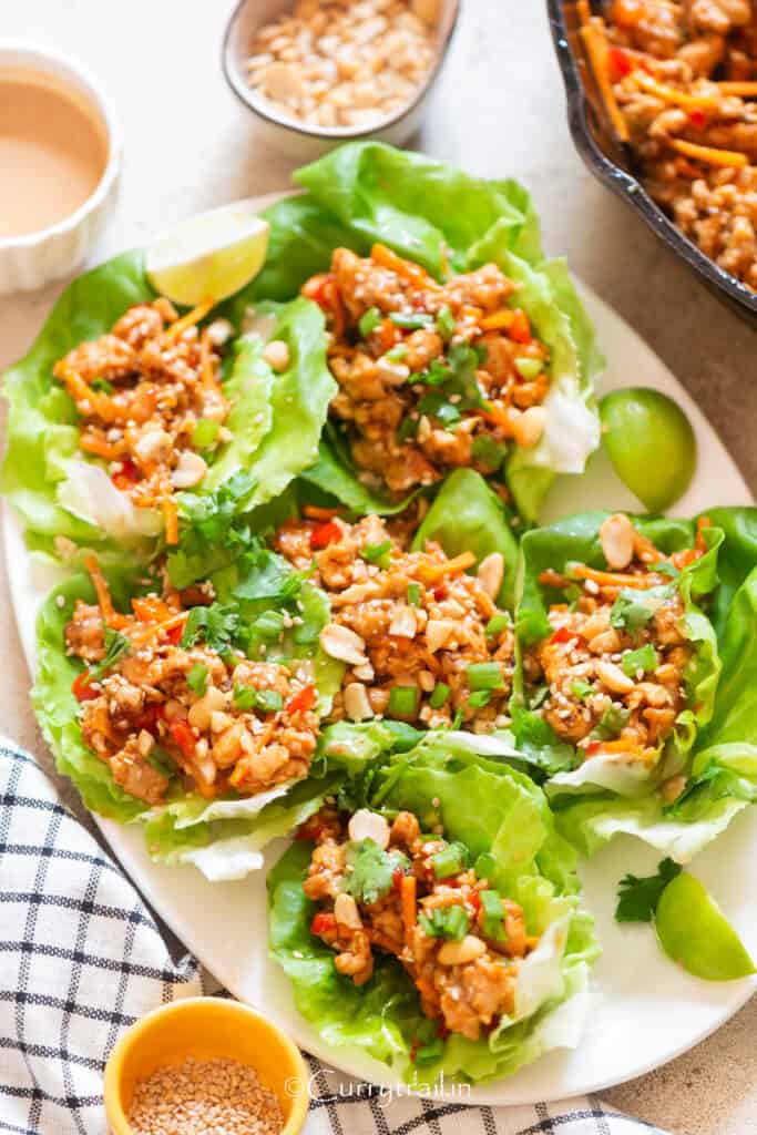 Lettuce cups filled with Asian ground chicken filling along with toppings.