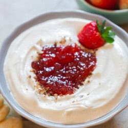 creamy cheesecake dip with berry jam as topping.