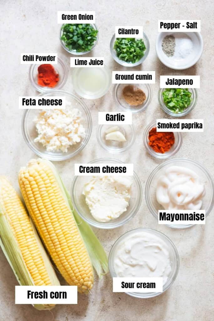 all the ingredients for mexican street corn dip on a table.