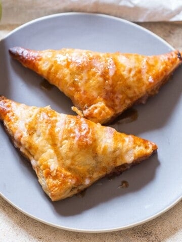 puff pastry filled with cinnamon apples and sugar glaze drizzed on top.