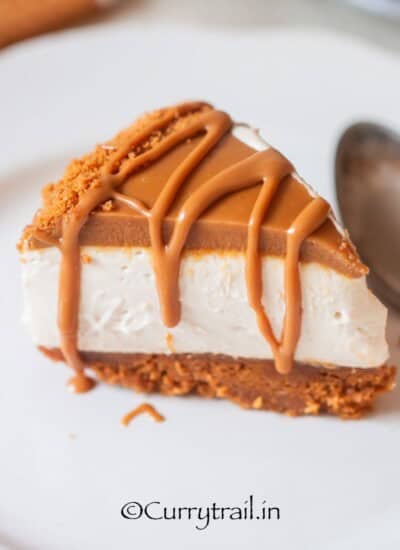 a slice of biscoff no bake cheesecake with crumb topping.