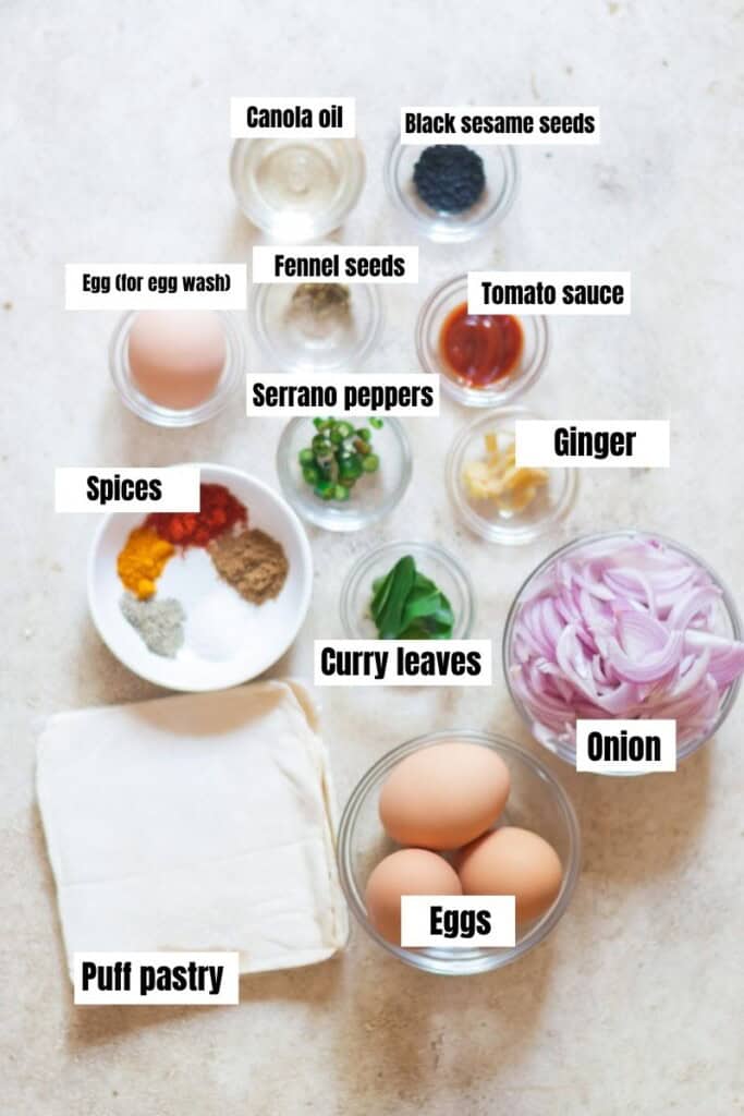 all ingredients for egg puff arranged on a white table.
